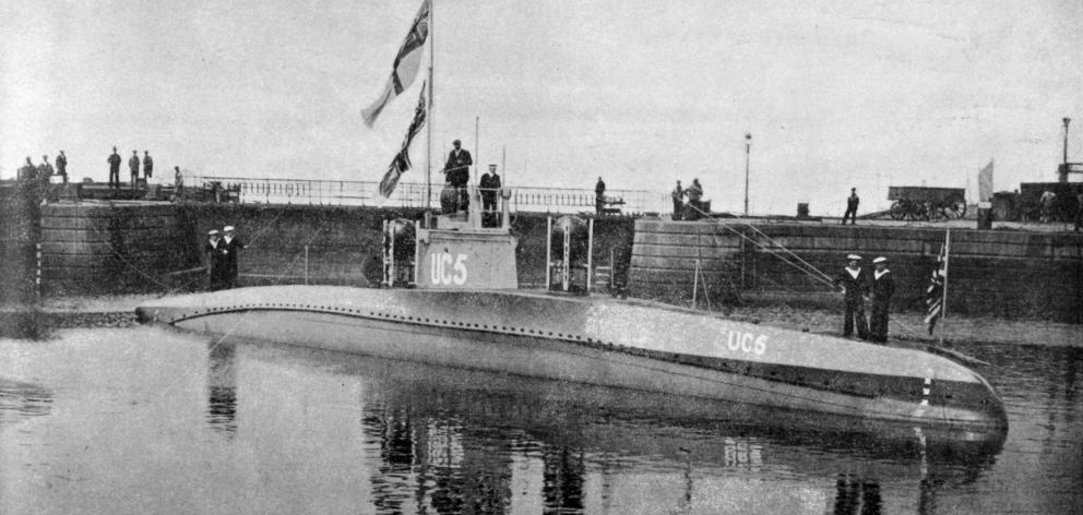 A captured German mine-laying submarine of the latest type in the dockyard basin at Temple Pier,...