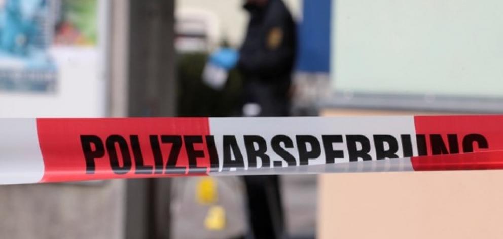 Police inspect the front of a mosque in Dresden the day after an improvised bomb destroyed the...