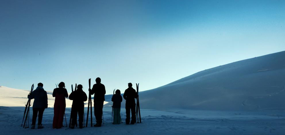 A group of cross-country skiers greet the new day at Meadow Hut at the Snow Farm. Photo: Stephen...