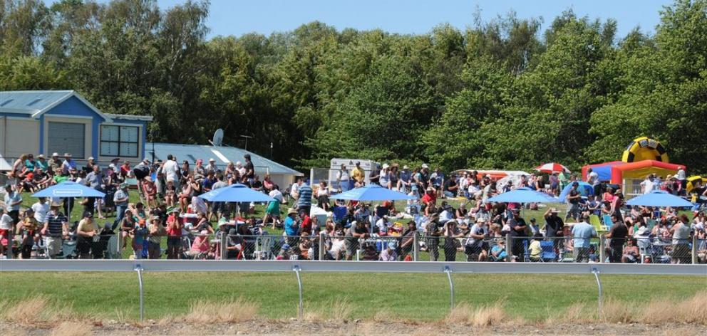 The crowd enjoys the sunshine at a previous Omakau trots. Photo by ODT.