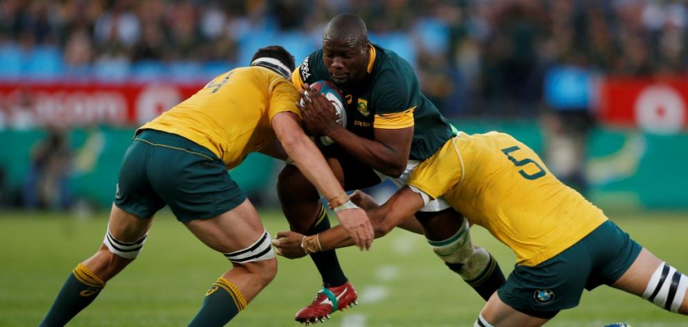 South Africa's Teboho Mohoje tries to bust through the Australian defence. Photo Reuters

