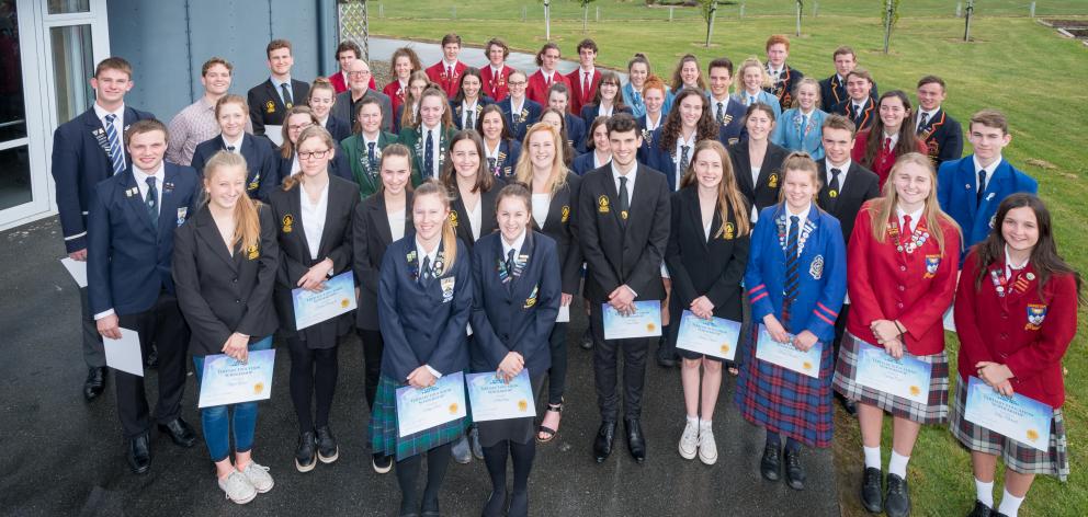 Recipients of Central Lakes Trust tertiary education scholarships join trust chairman Malcolm Macpherson and guest speaker, Student Volunteer Army founder Sam Johnson, after the awards function in Cromwell yesterday. Photo supplied.