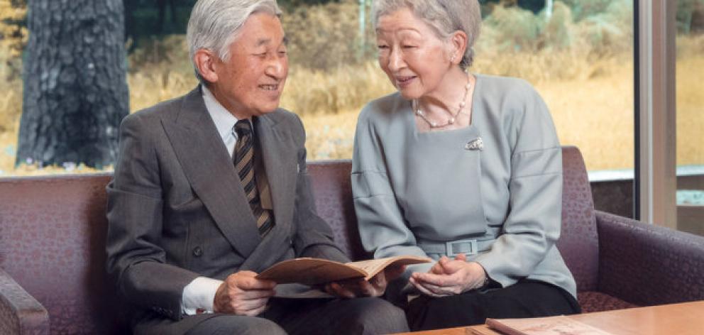 Japan's Emperor Akihito and Empress Michiko read a book at the Imperial Palace in Tokyo. Photo:...