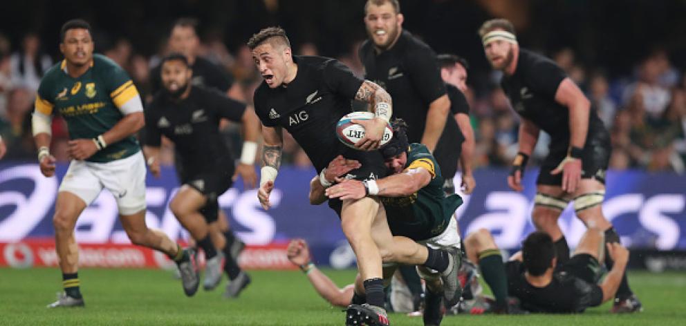 Halfback T J Perenara on the charge for the All Blacks against South Africa. Photo Getty