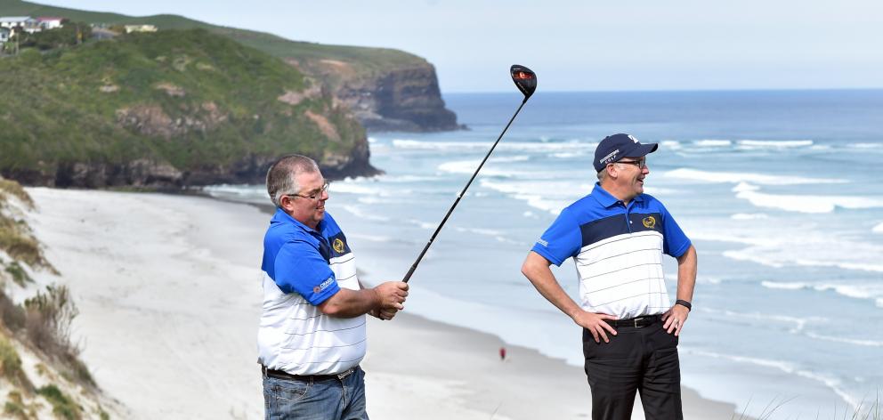 Otago masters No1 Andrew Hobbs plays a shot, watched by manager Chris Timms, at the ninth hole at...