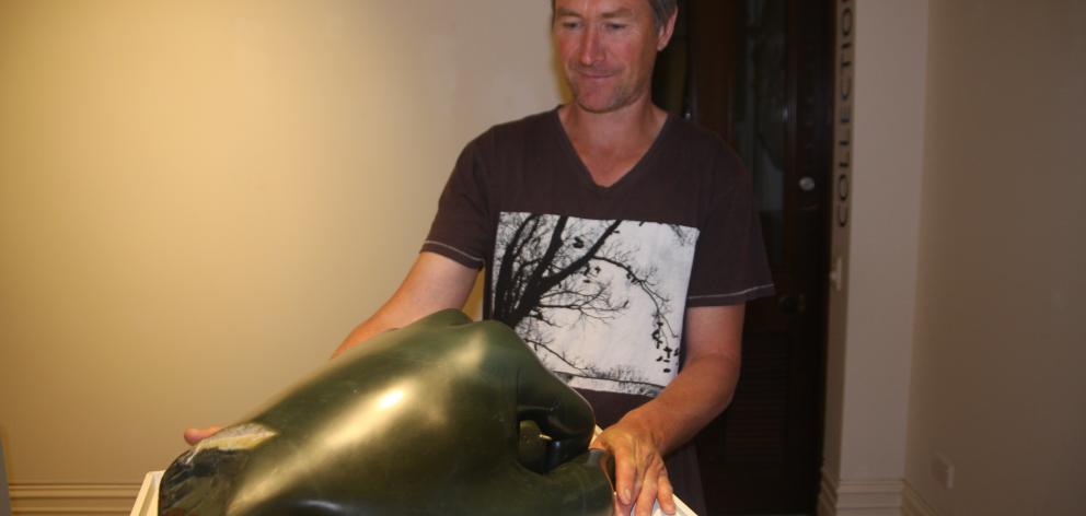 Luggate artist Joshua Olley adjusts one of his pieces at the Forrester Gallery. Photo: Shannon...