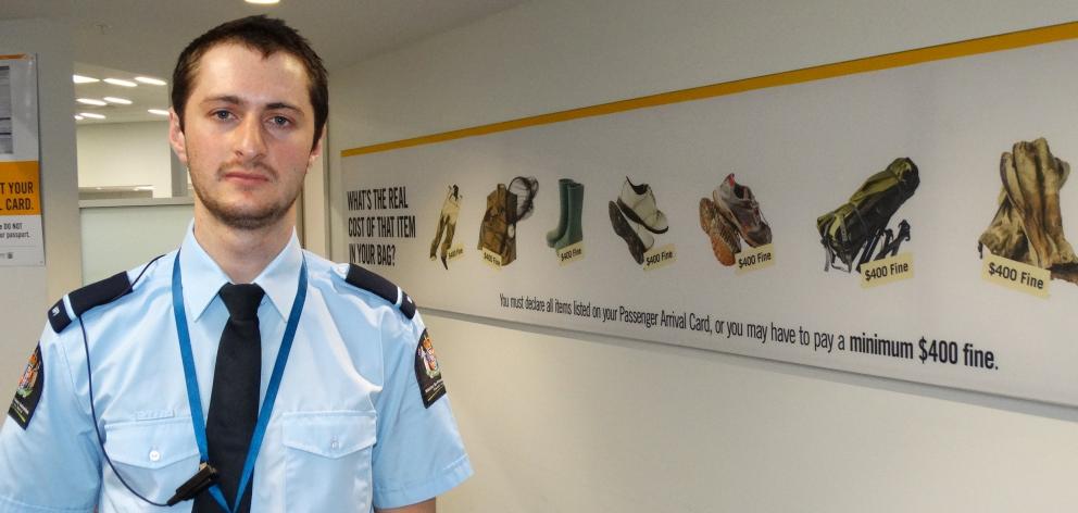 Quarantine officer Charles Frazer next to a biosecurity sign. Photo: Paul Taylor.