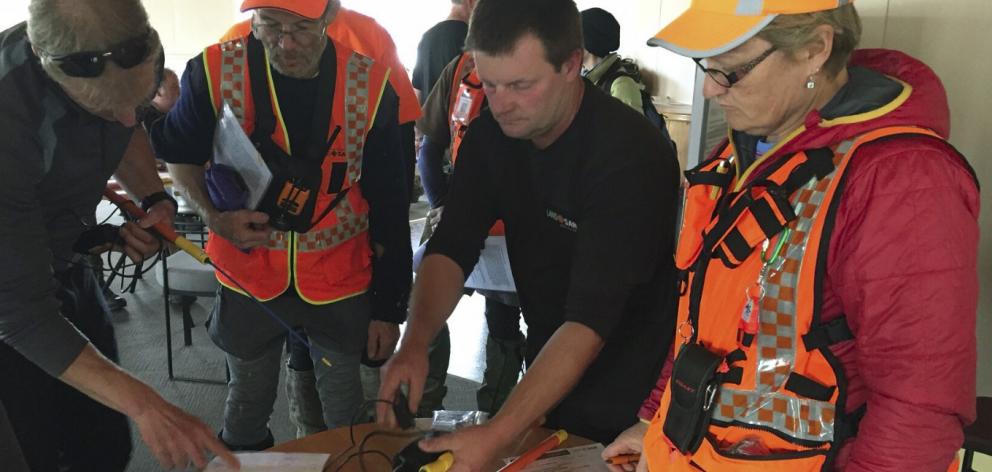 Searchers are issued with personal tracking devices as the Stewart Island training exercise focusing on the disappearance of Joe Freiman gets under way. Photo from NZ Police.