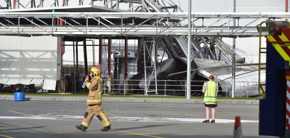 A firefighter walks from the scene of the silo collapse at the Fonterra Edendale plant last month...