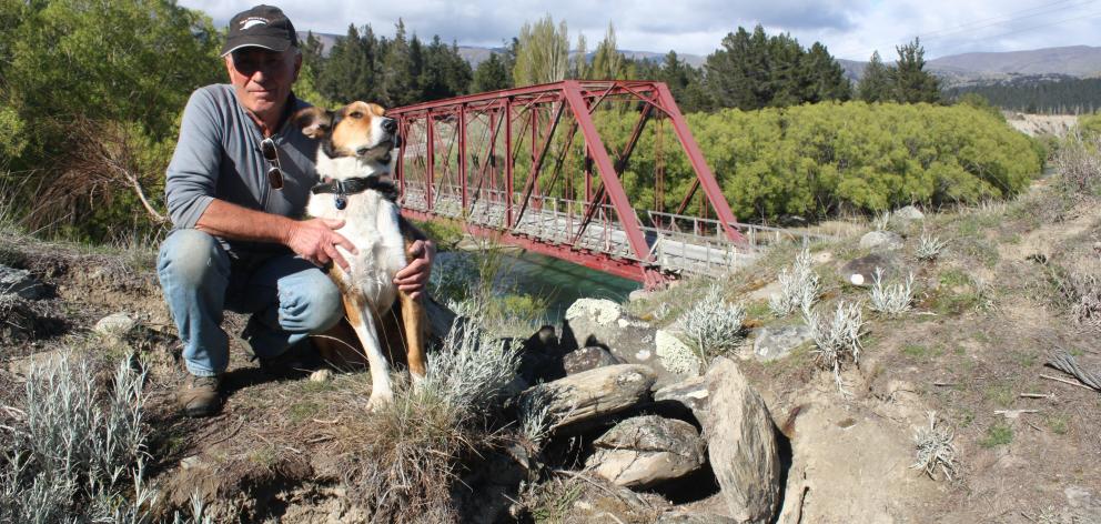 Luggate Community Association chairman Graeme Perkins and his dog Mac look over the damage done...