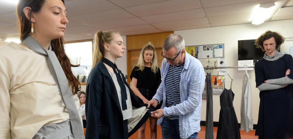 Void owner Neil Gaudin inspects designs modelled by Frank Jansen van Rensburg (left) and...