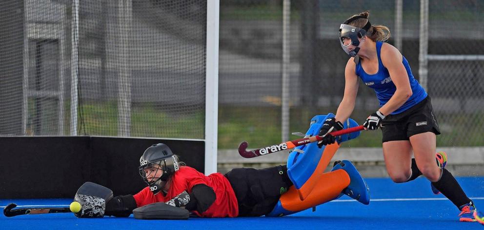 New Black Sticks goalkeeper Ginny Wilson (also inset) stops the ball while fellow Southern player...