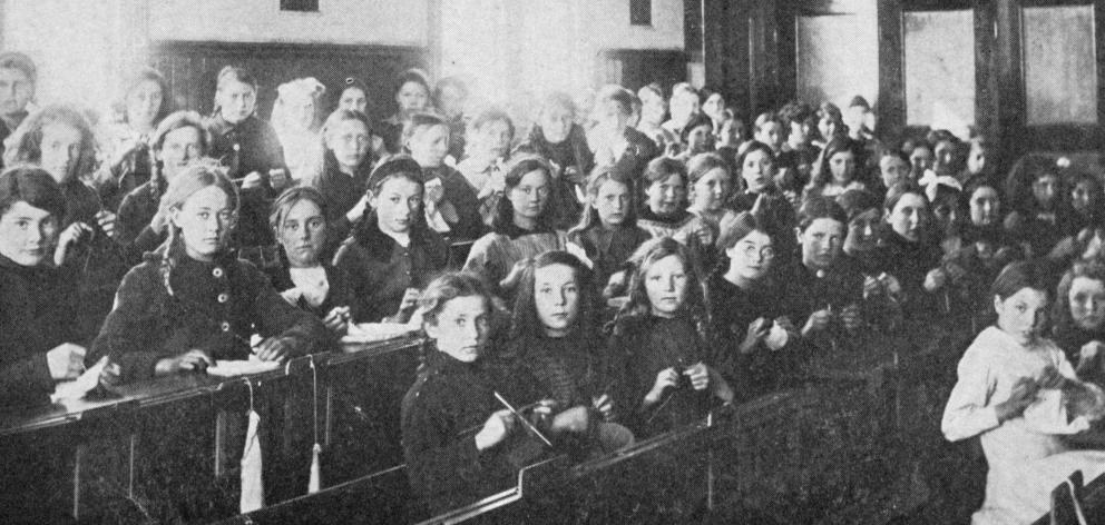 Working for our boys at the front: a knitting class at Kaitangata school. — Otago  Witness, 8.11...