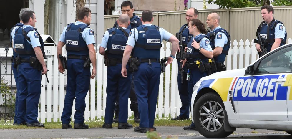 Armed police gather outside a house in the Dunedin suburb of Abbotsford yesterday. Photo by Gregor Richardson.