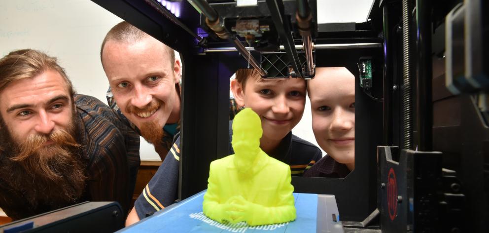 Digital Dunedin Fab Lab business partners Josh Smith (left) and Keir Russell, along with science club participants Matthew Gibbens (11) and Gabriel Vink (12), watch a 3D model of Mr Smith being printed at Kavanagh College yesterday. Photo by Gregor Richar