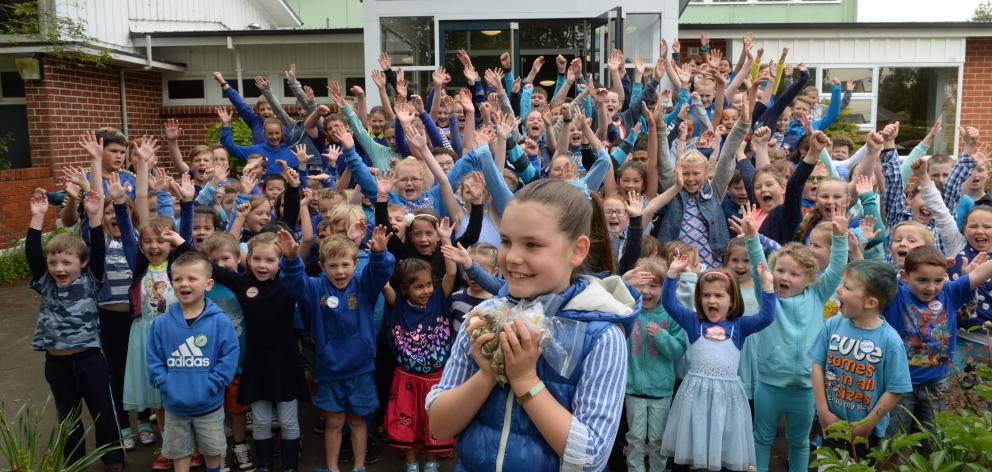 Silverstream School pupil Keisha Hollands holds up some of the money she and fellow pupils raised from a blue mufti day yesterday. Photo by Linda Robertson.