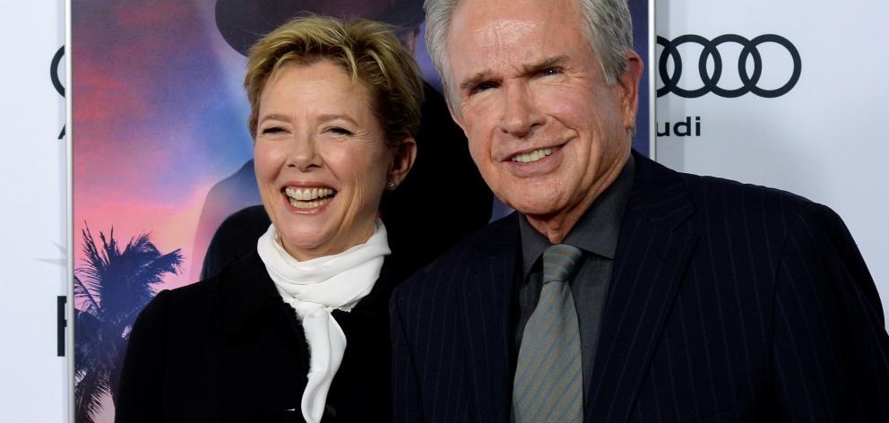 Producer/director Warren Beatty and cast member/ wife Annette Bening arrive at the premiere of ...