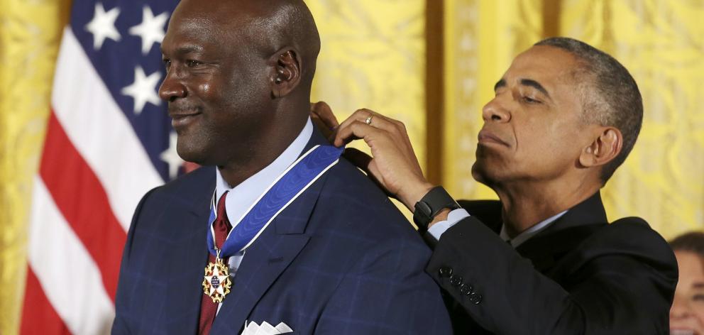 President Barack Obama awards NBA great Michael Jordan the Presidential Medal of Freedom during a...