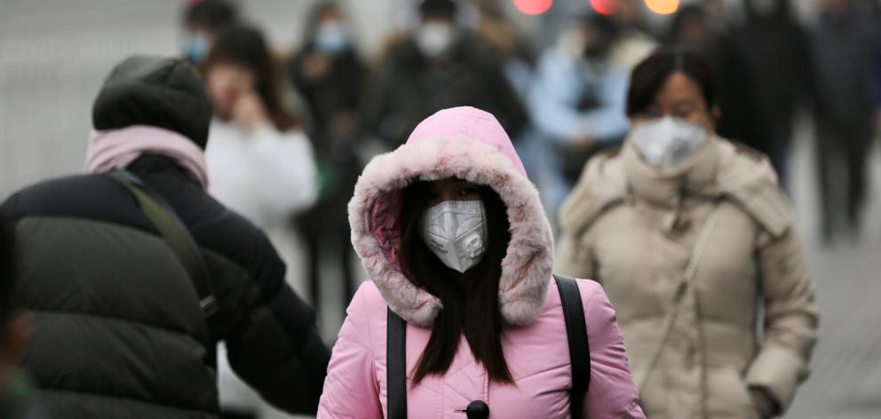 Commuters wear masks to counter smog in Beijing this week. Photo: Reuters