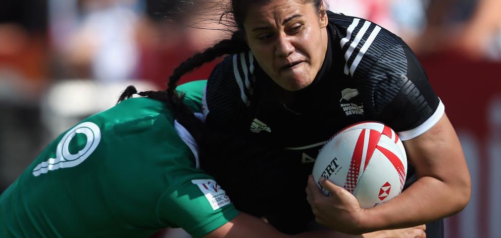 Shakira Baker of New Zealand is tackled by Lucy Mulhall of Ireland at the Emirates Dubai Rugby...