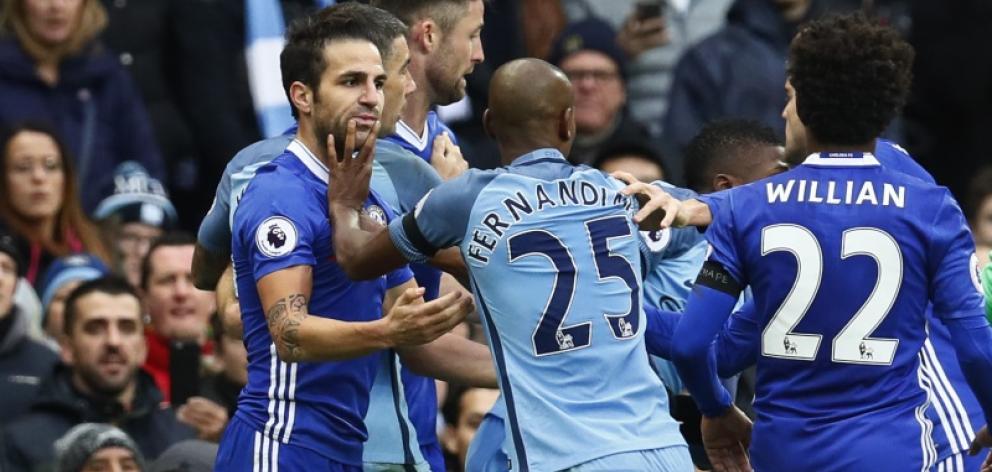 Manchester City's Fernandinho clashes with Chelsea's Cesc Fabregas before being sent off. Photo:...