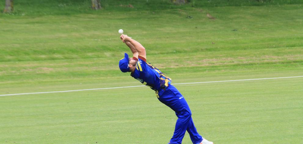 Otago fielder Neil Broom puts down a catch.  