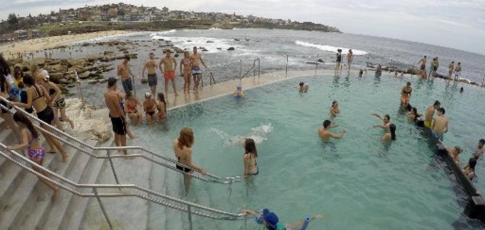 Swimmers cool off in a salt water ocean pool at Sydney's beachside suburb of Bronte,during an...