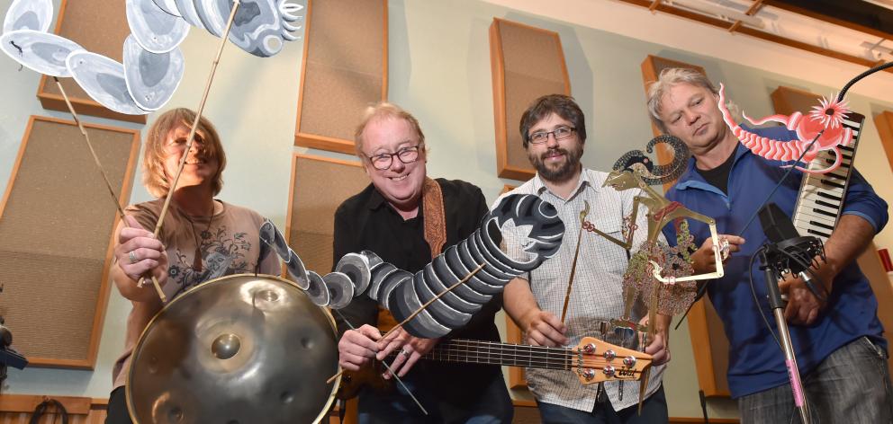Having fun with Javanese shadow puppets while creating the soundtrack to a new educational film at the University of Otago music department's Albany St studio are (from left) Dr Ian Chapman, Associate Prof Rob Burns, Dr Dan Bendrups and Dr Trevor Coleman.