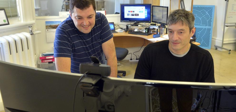 Greg Peyroux (left) and Benoit Auvray examine a model at their Iris Data Science office this week...