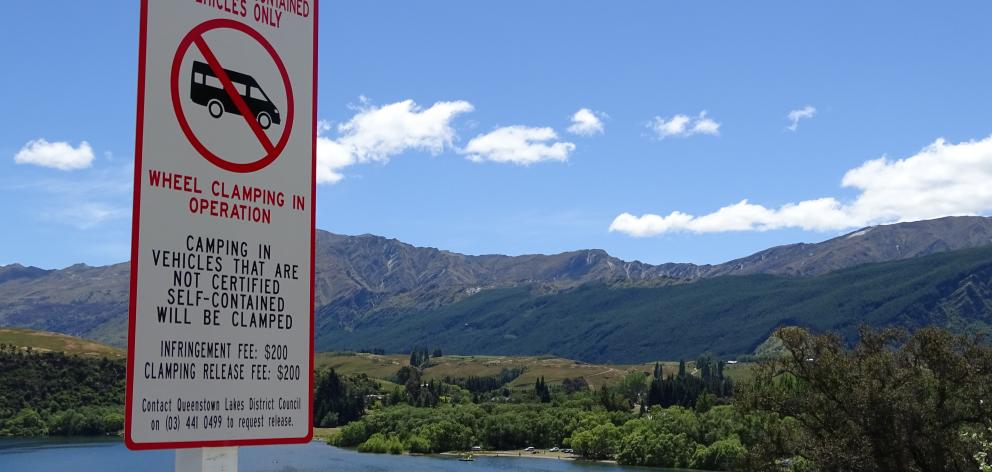 A new sign at the entrance to the northern end of Lake Hayes warns against anyone freedom camping...