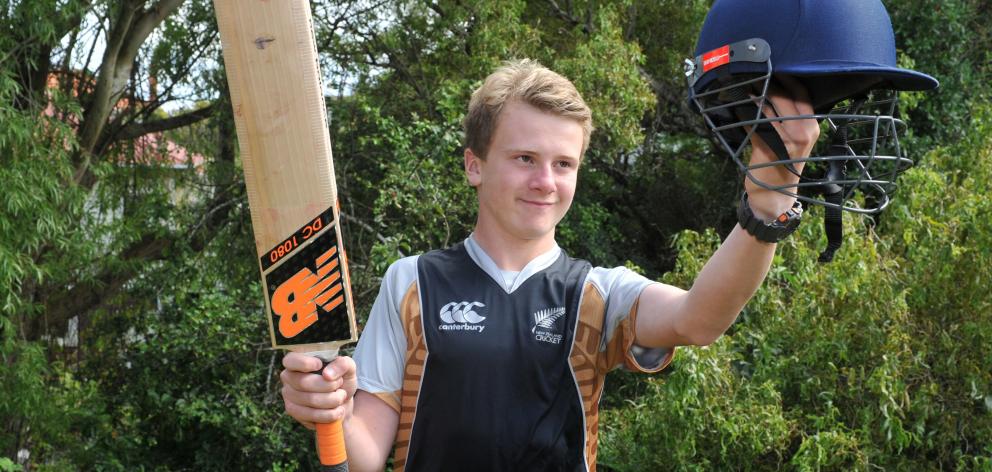 Xavier Chisholm with the tools of his trade, given to him by New Zealand cricketer Neil Broom....