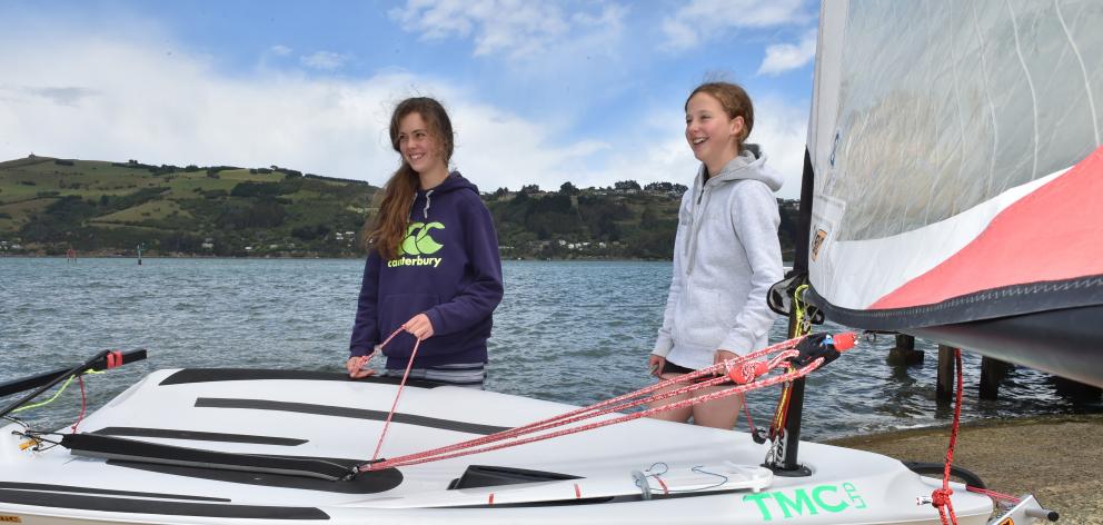 Anna Walrond (14, left) and Miriam Barton (13) rig an O'pen Bic dinghy for a sail on Otago...