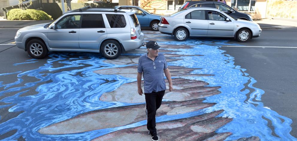 David Cockerill walks across the 3-D ’’river crossing’’ in North Dunedin yesterday. Photo: Peter...
