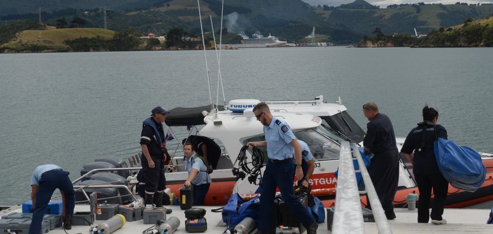 Members of the police national dive squad prepare to search for a diver, missing off the Otago...