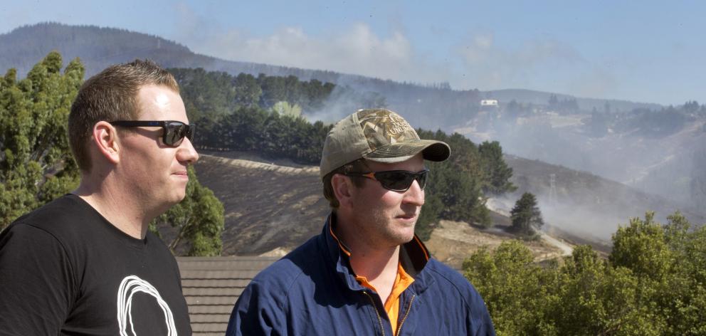 Simon Grace (L) and Hamish Tovey look towards Mr Grace's family home stood in the Port Hills...