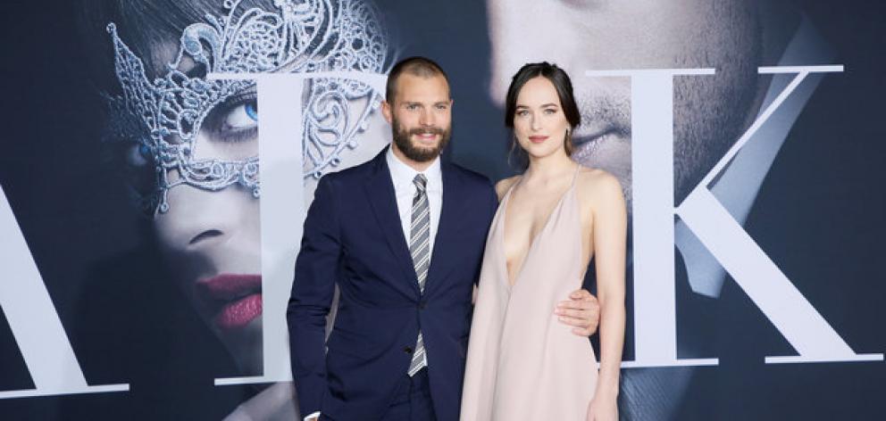 Jamie Dornan (Christian Grey) and Dakota Johnson (Ana Steele) at the premiere of the film 'Fifty Shades Darker'. Photo: Reuters