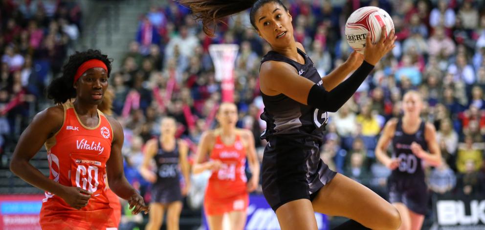 Maria Tutaia of New Zealand collects the ball ahead of Ama Agbeze of England during the Quad Series netball match