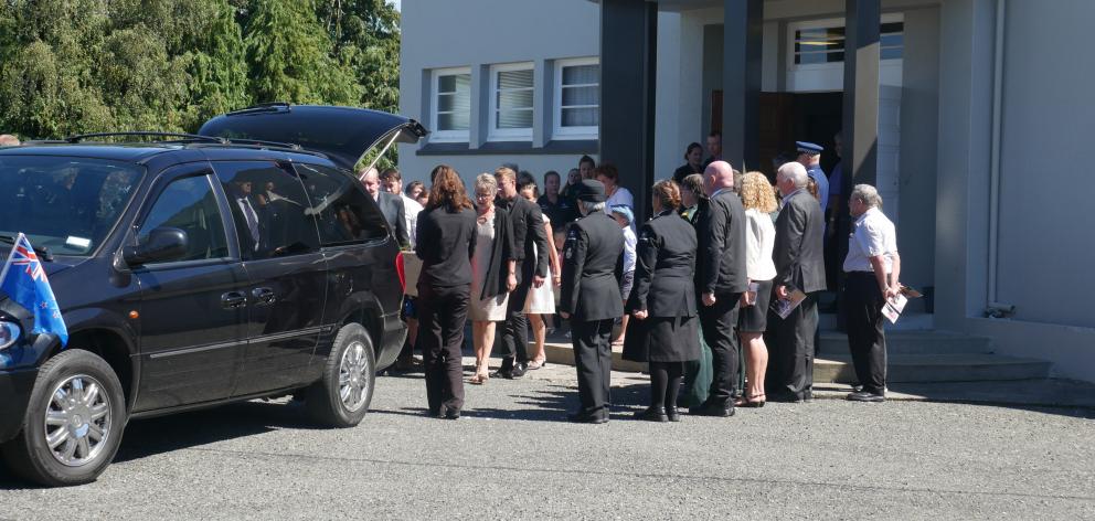 Mourners gather as Russell Glendinning’s coffin is carried from the Lumsden Memorial Hall. Photo:...
