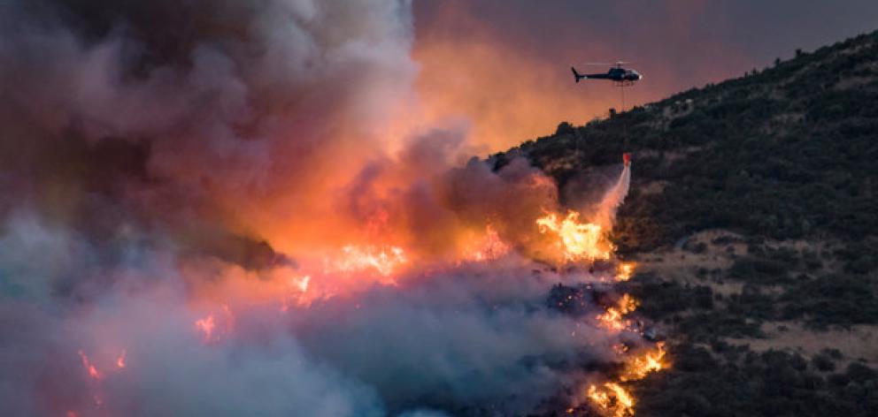 Helicopters are set to survey the damage done by the Port Hills fire overnight in Christchurch. Photo: Reuters Helicopters are set to survey the damage done by the Port Hills fire overnight in Christchurch. Photo: Reuters