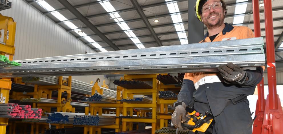 Storeman-distribution Phil Mattocks stocks shelves in Steel & Tube’s new building. Photo: Gregor...