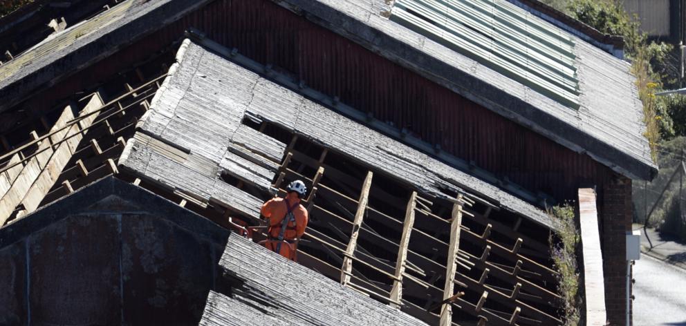 Cere Environmental NZ contractors are working to remove the asbestos roof of the former Sims...