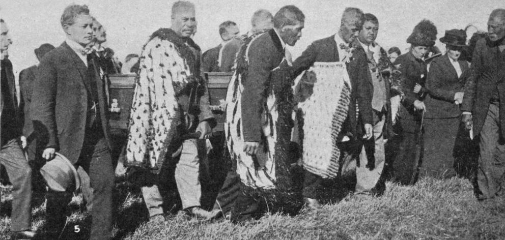 Pall-bearers carry the coffin of the late Hon T. Parata up the hill to his last resting place in...