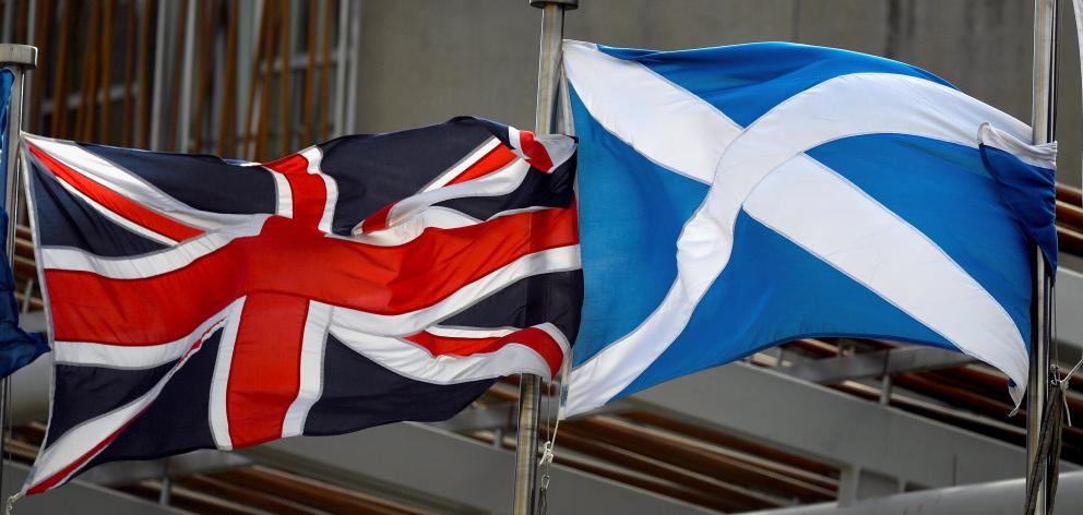  A Saltire, and Union Jack flags flutter in the wind outside the Scottish Parliament on March 13, 2017 in Edinburgh, Scotland. Getty