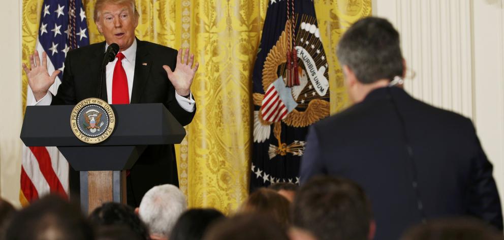 US President Donald Trump takes a question from CNN reporter Jim Acosta (right) during a news conference at the White House. Photo: Reuters