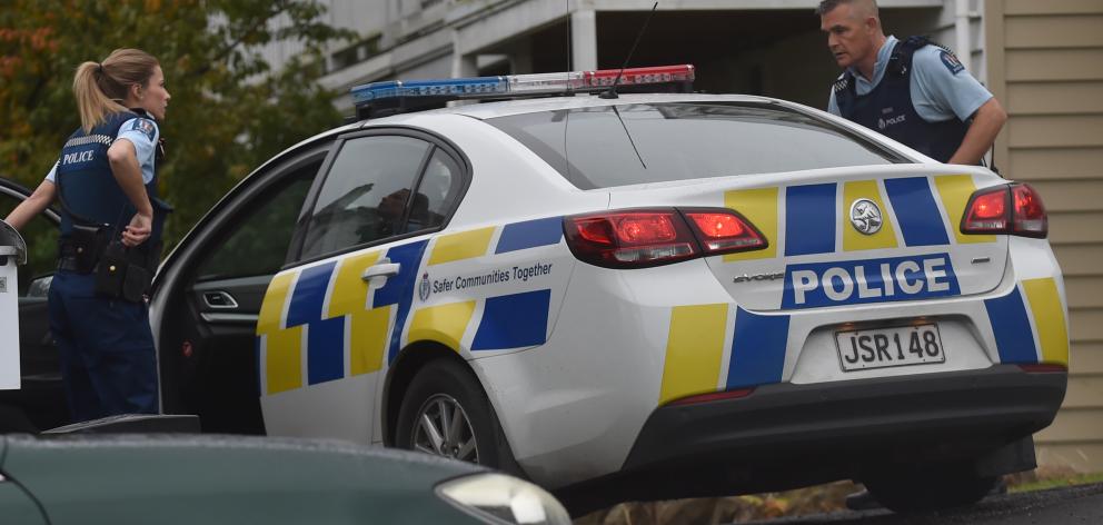 Officers attend  the scene of a serious assault in Melville St, Dunedin, yesterday afternoon....