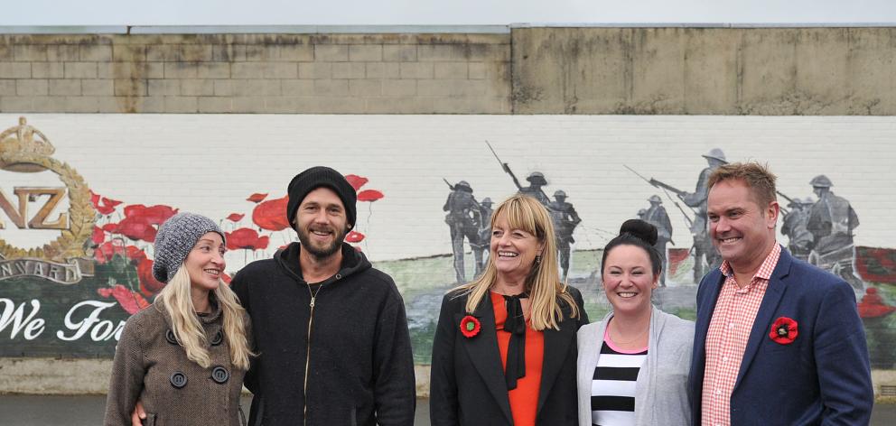 At a new Anzac-themed mural in Mosgiel yesterday are (from left) artists Tessa Petley and Daniel...