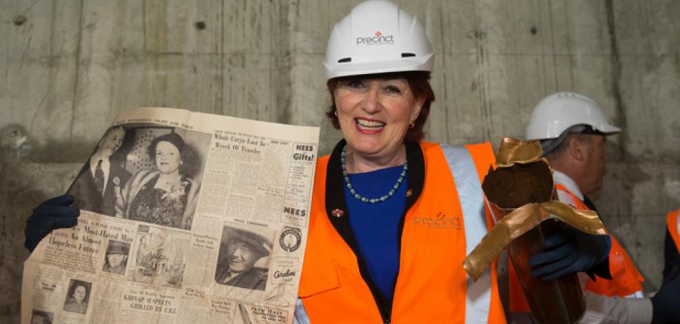Arts, Culture and Heritage Minister Maggie Barry with a newspaper from the time capsule found buried in the Bowen State Building, next to Parliament, Wellington. Photo: NZ Herald