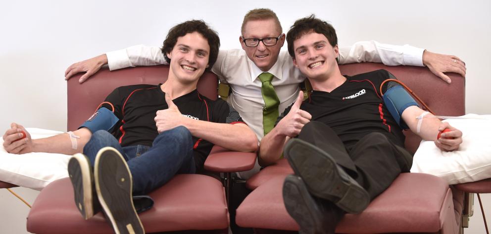 Identical twins Callum (left) and Matthew Sutherland join their employer John Moyle at the Dunedin Donor Centre this week. Photo: Peter McIntosh