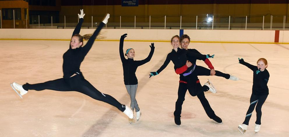 Sarah MacGibbon (21) leaps in front of Lucienne Holtz (14) (left), Reuben Dougherty (17), who is holding Hannah Sime (14), and Rebekah Sime (10) (right) at the Dunedin Ice Stadium before leaving for Sydney yesterday. Photo: Stephen Jaquiery