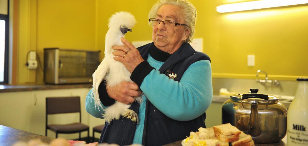 Isobel Robinson holds a white silkie hen as she prepares to feed a flock of peckish bird lovers...